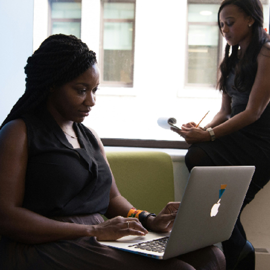 Two African women is working at a office.